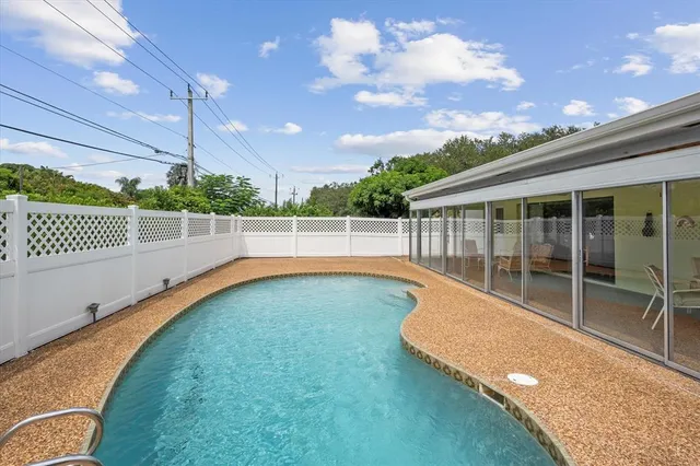 a view of a backyard with a swimming pool