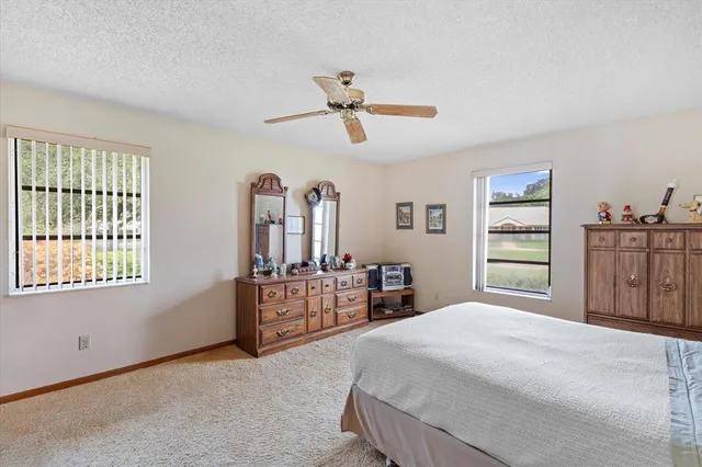 a bedroom with a large bed and dresser