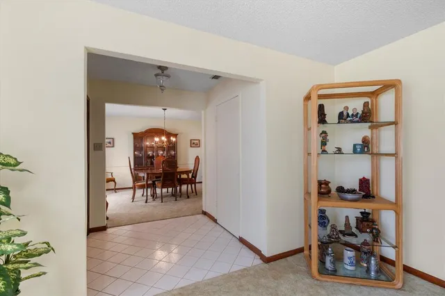 a living room with furniture and a dining table with wooden floor