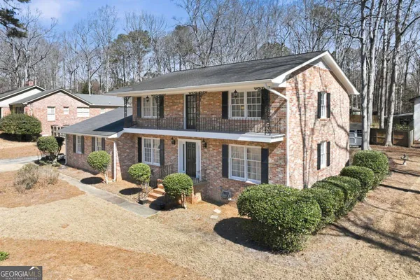 a front view of a house with yard porch and seating space