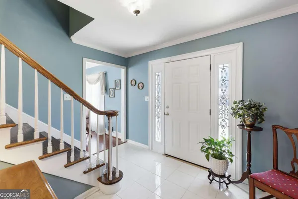 a large white kitchen with lot of stainless steel appliances