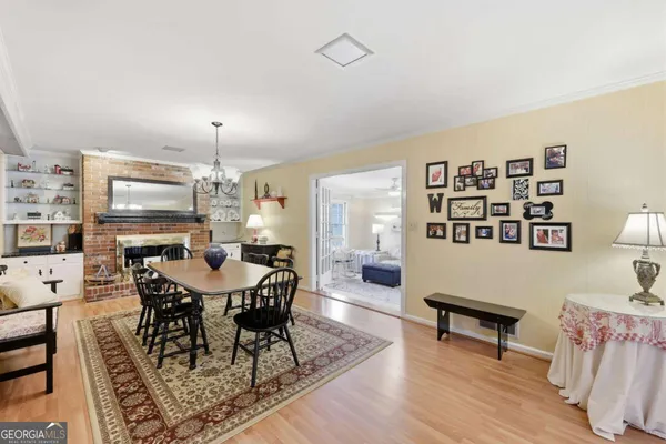 a living room with furniture a dining table and a flat screen tv