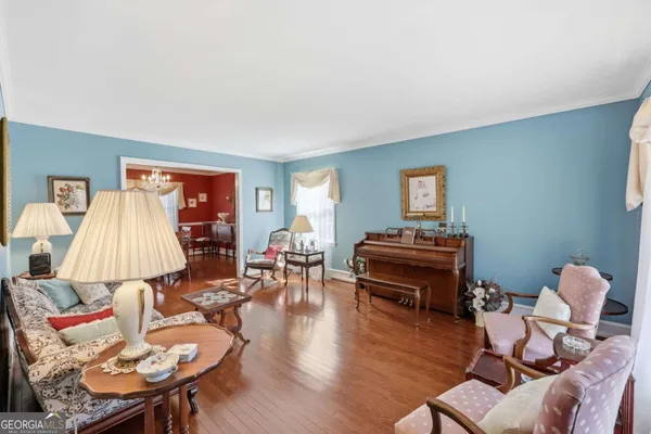 a bedroom with a bed a flat screen tv and a large window with the outer view