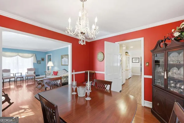a view of a hallway with wooden floor and closet