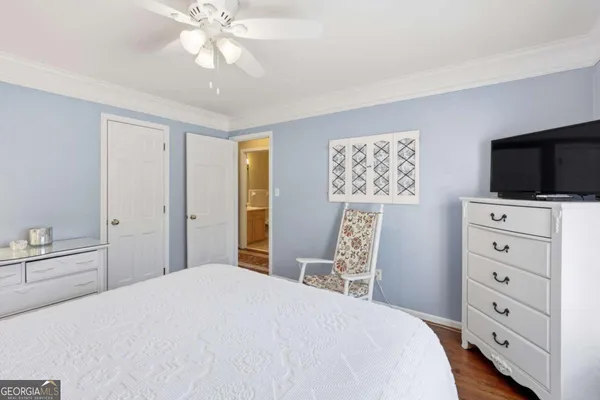 a bedroom with furniture and a large window