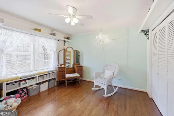 a bedroom with furniture and a window
