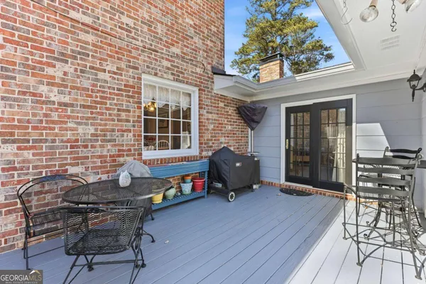 a backyard of a house with barbeque oven table and chairs