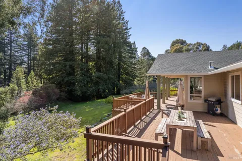 an aerial view of a house with a yard basket ball court and outdoor seating