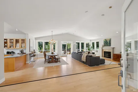 a kitchen with stainless steel appliances granite countertop a stove a sink and a granite counter tops with white cabinets