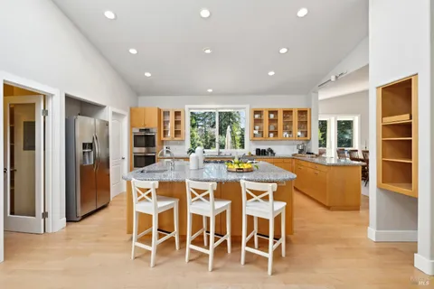 a spacious bathroom with a granite countertop sink mirror and a