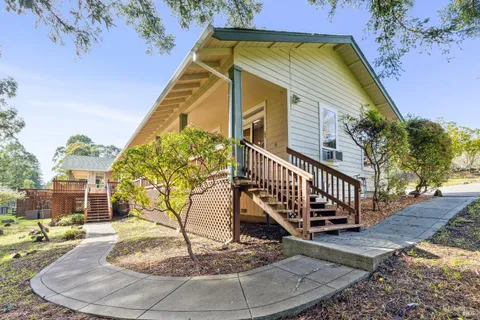 a living room with furniture a large window and a table