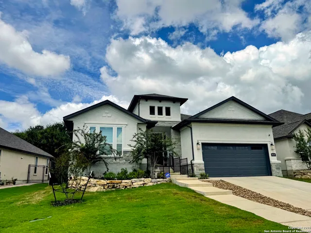 a front view of a house with a garden and yard