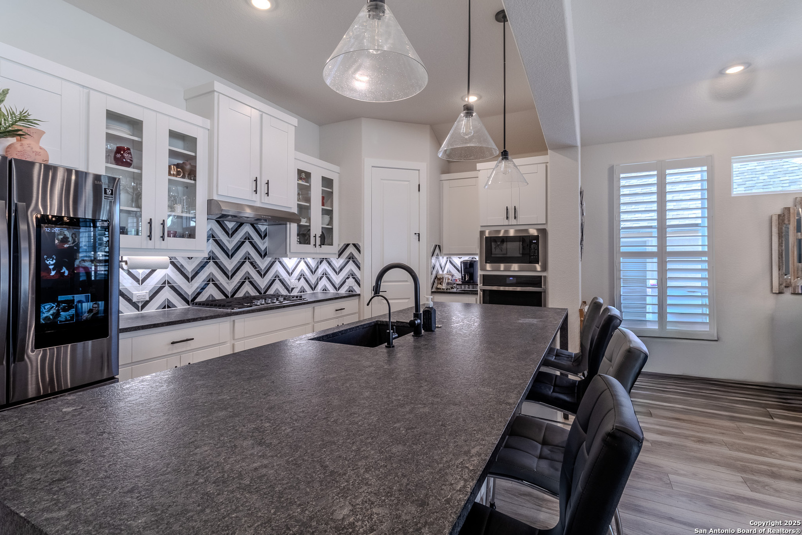 8519 Nichols Tree Boerne, TX 78015 - Photo 12 of 27 a kitchen with stainless steel appliances granite countertop a stove sink and cabinets
