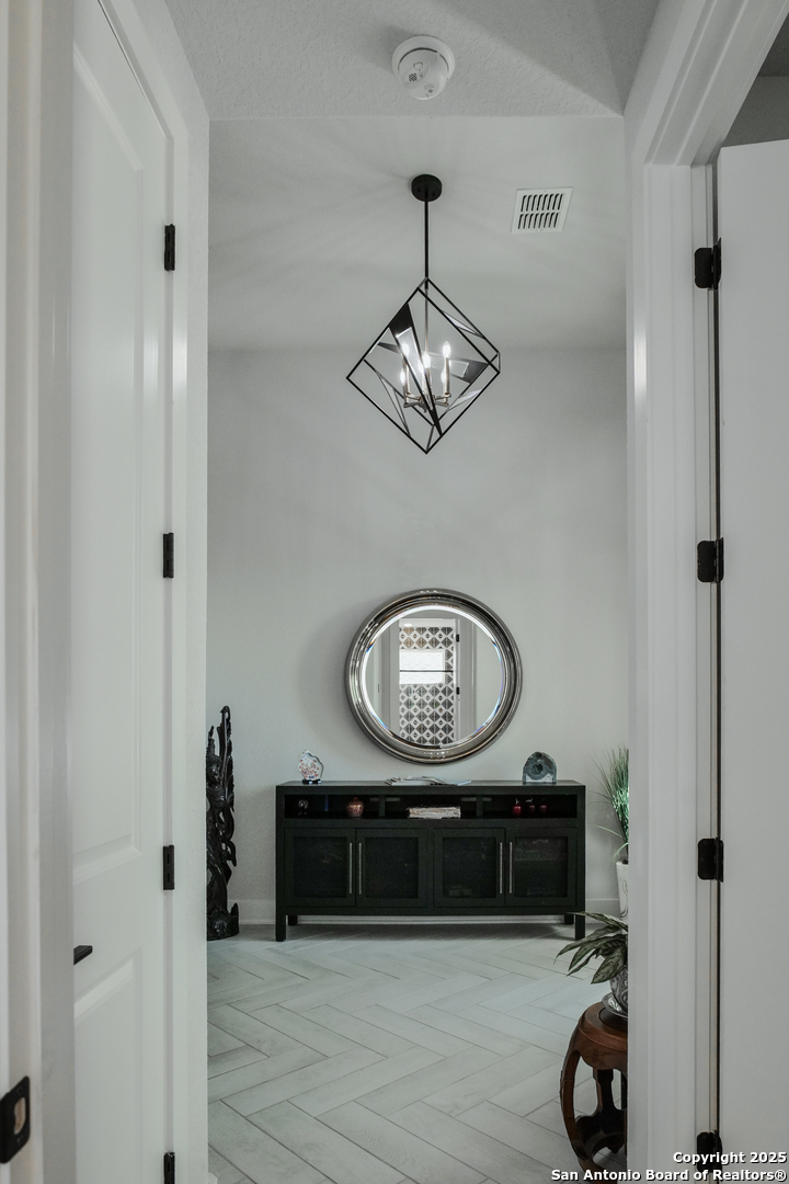 8519 Nichols Tree Boerne, TX 78015 - Photo 7 of 27 a room with a mirror and a wooden floor