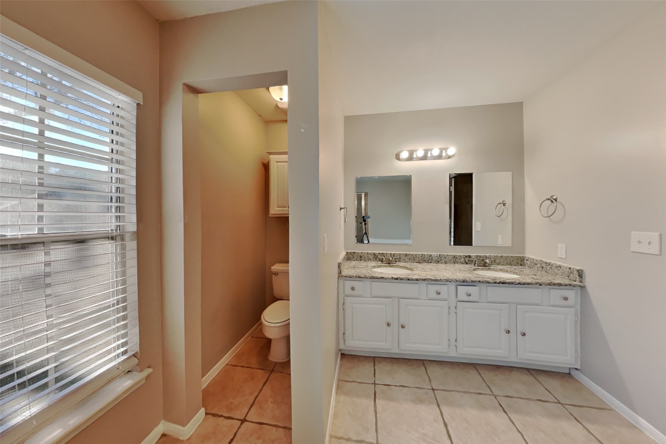 7611 Round Grove Lane Houston, TX 77095 - Photo 11 of 22 a bathroom with a granite countertop sink and a mirror