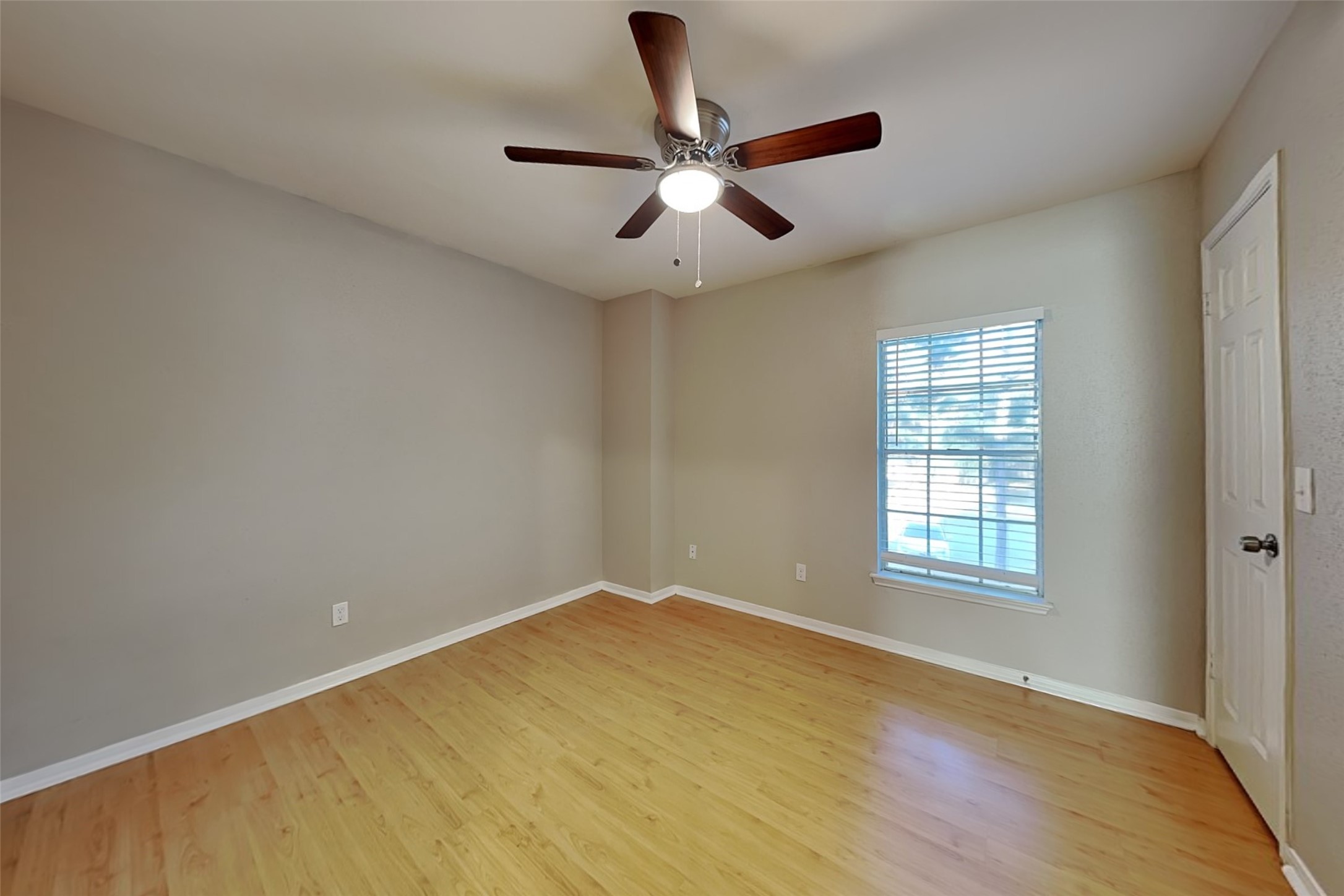 7611 Round Grove Lane Houston, TX 77095 - Photo 12 of 22 a view of empty room with wooden floor and fan