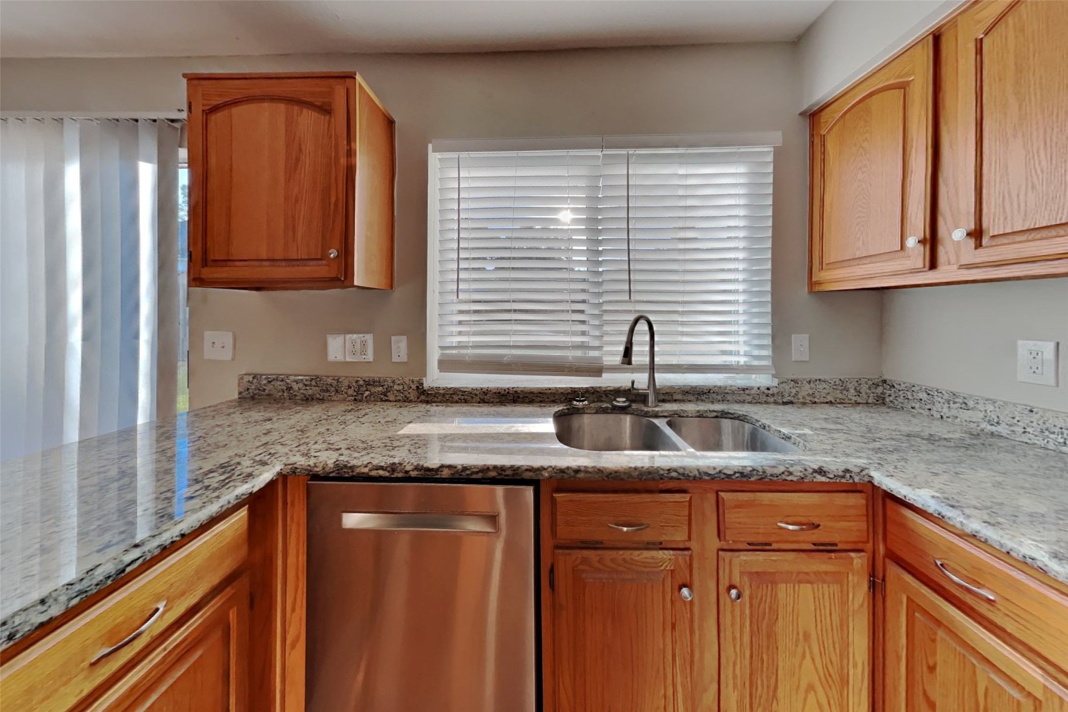 7611 Round Grove Lane Houston, TX 77095 - Photo 5 of 22 a kitchen with granite countertop stainless steel appliances sink and cabinets