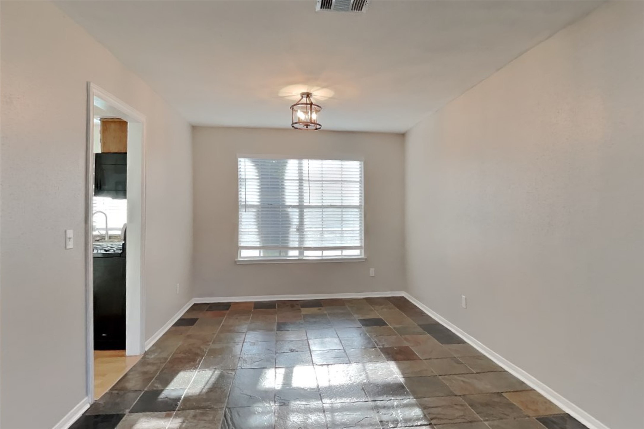 7611 Round Grove Lane Houston, TX 77095 - Photo 7 of 22 an empty room with windows and ceiling fan
