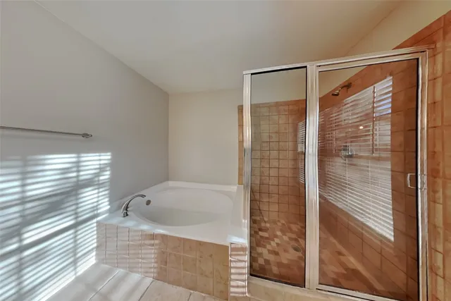 a bathroom with a bathtub and shower