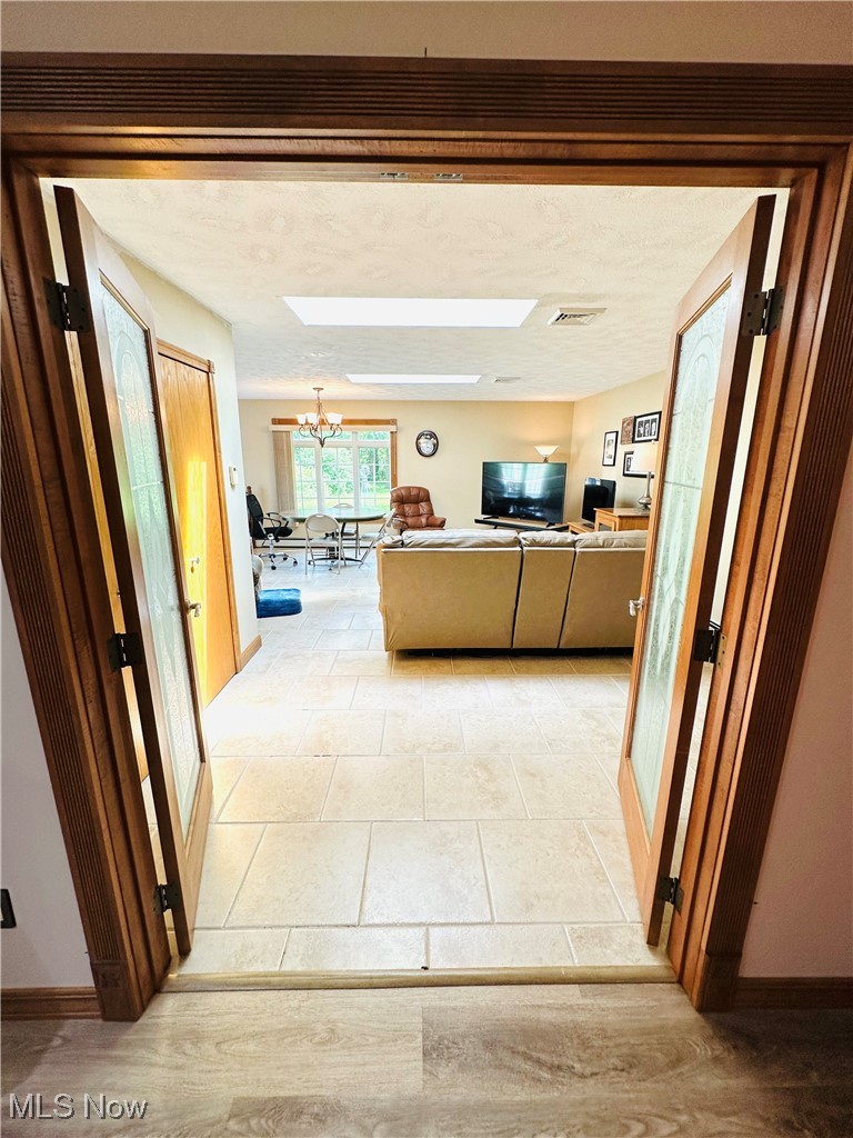 1684 Morris Street Mineral Ridge, OH 44440 - Photo 28 of 50 Hallway featuring a chandelier and baseboards