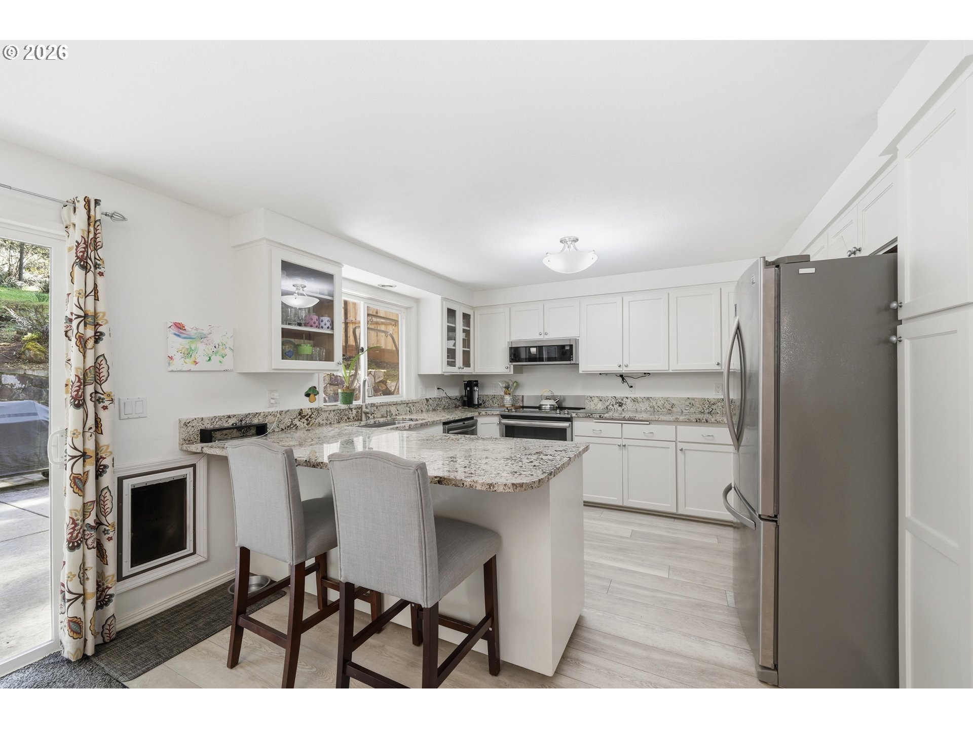 88119 Tiki Lane Springfield, OR 97478 - Photo 11 of 35 a kitchen with stainless steel appliances a sink a stove a refrigerator cabinets and a dining table