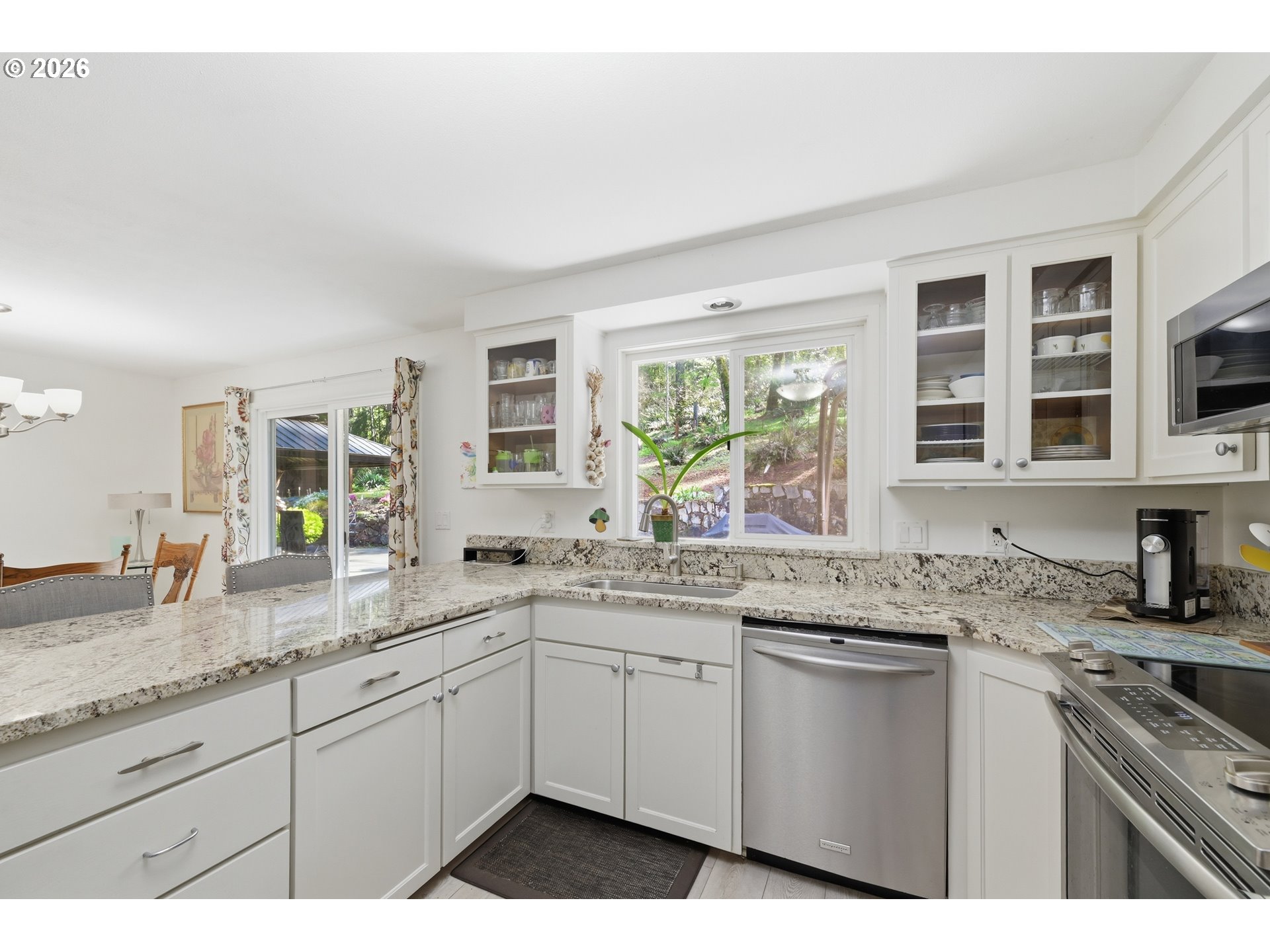 88119 Tiki Lane Springfield, OR 97478 - Photo 13 of 35 a kitchen with granite countertop cabinets stainless steel appliances a sink and a window