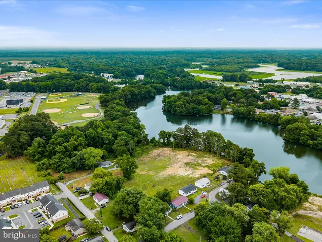 an aerial view of residential houses with outdoor space and swimming pool