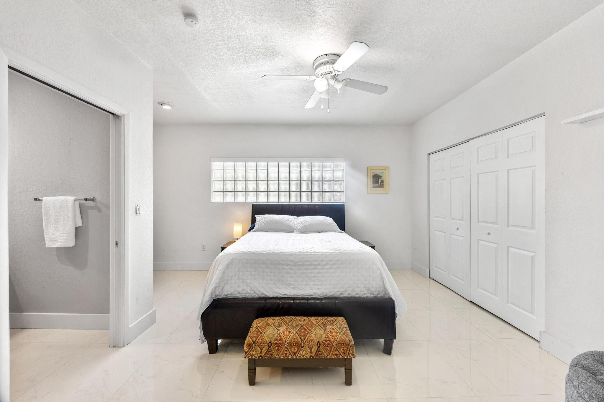 5021 Southwest 201st Terrace Southwest Ranches, FL 33332 - Photo 20 of 50 a bedroom with a bed and a chandelier