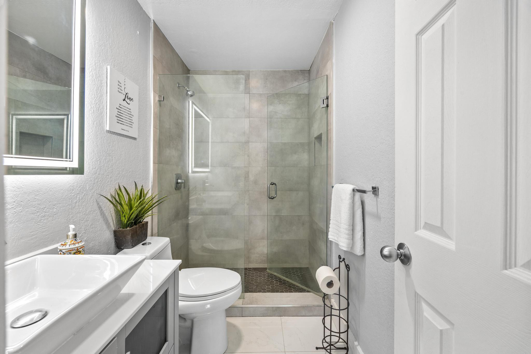 5021 Southwest 201st Terrace Southwest Ranches, FL 33332 - Photo 23 of 50 a bathroom with a sink a toilet and shower
