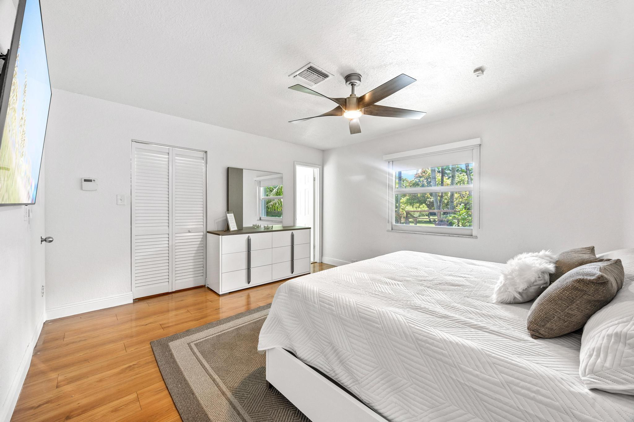 5021 Southwest 201st Terrace Southwest Ranches, FL 33332 - Photo 29 of 50 a bedroom with a large bed and a chandelier