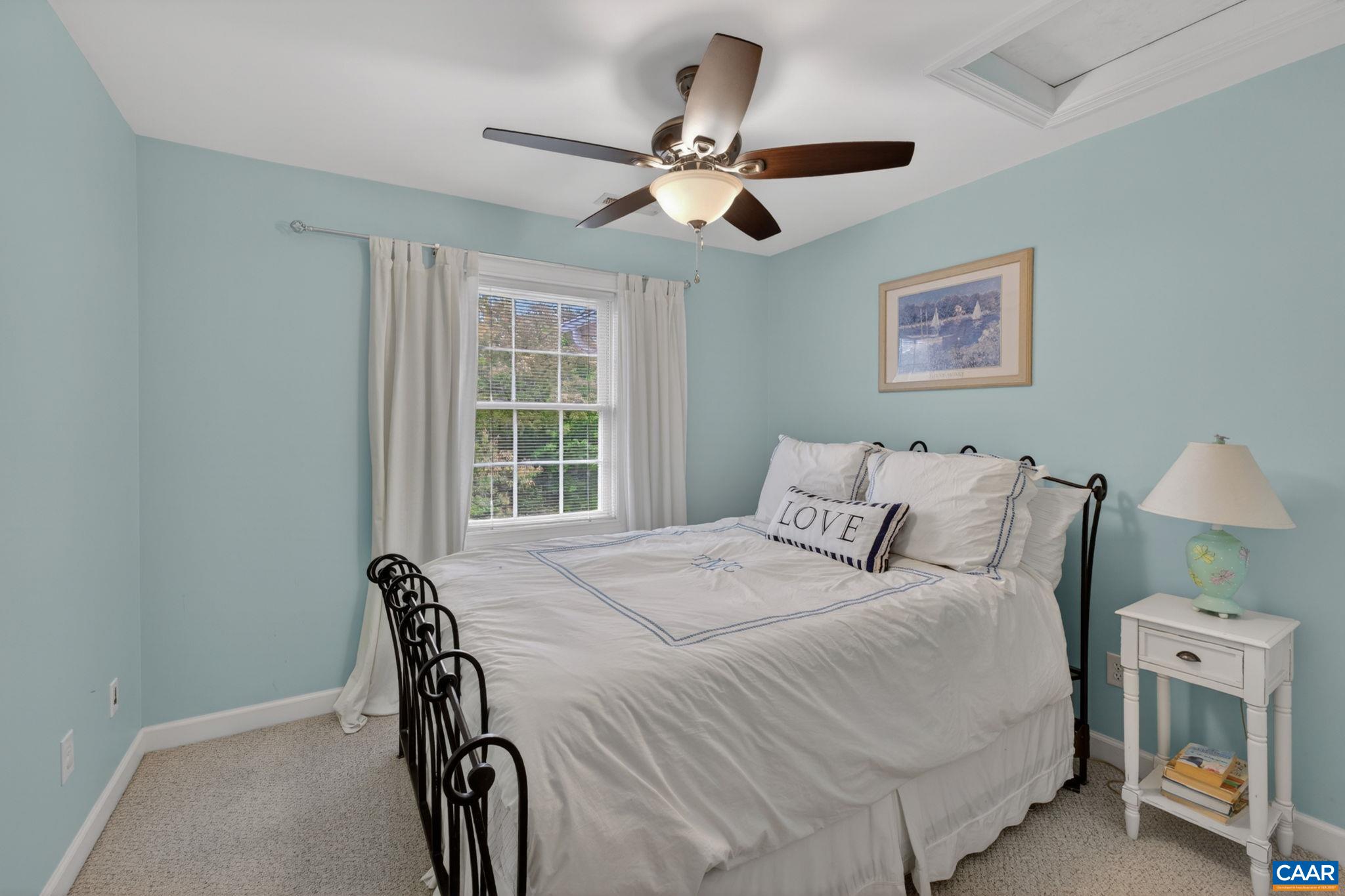 511 Taylor Ridge Way Palmyra, VA 22963 - Photo 27 of 57 a bedroom with a bed and a chandelier