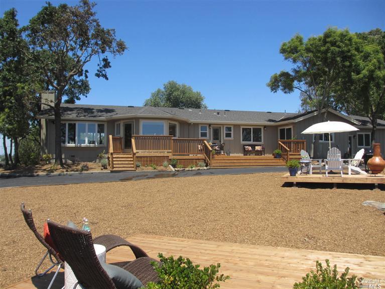 a front view of a house with swimming pool table and chairs