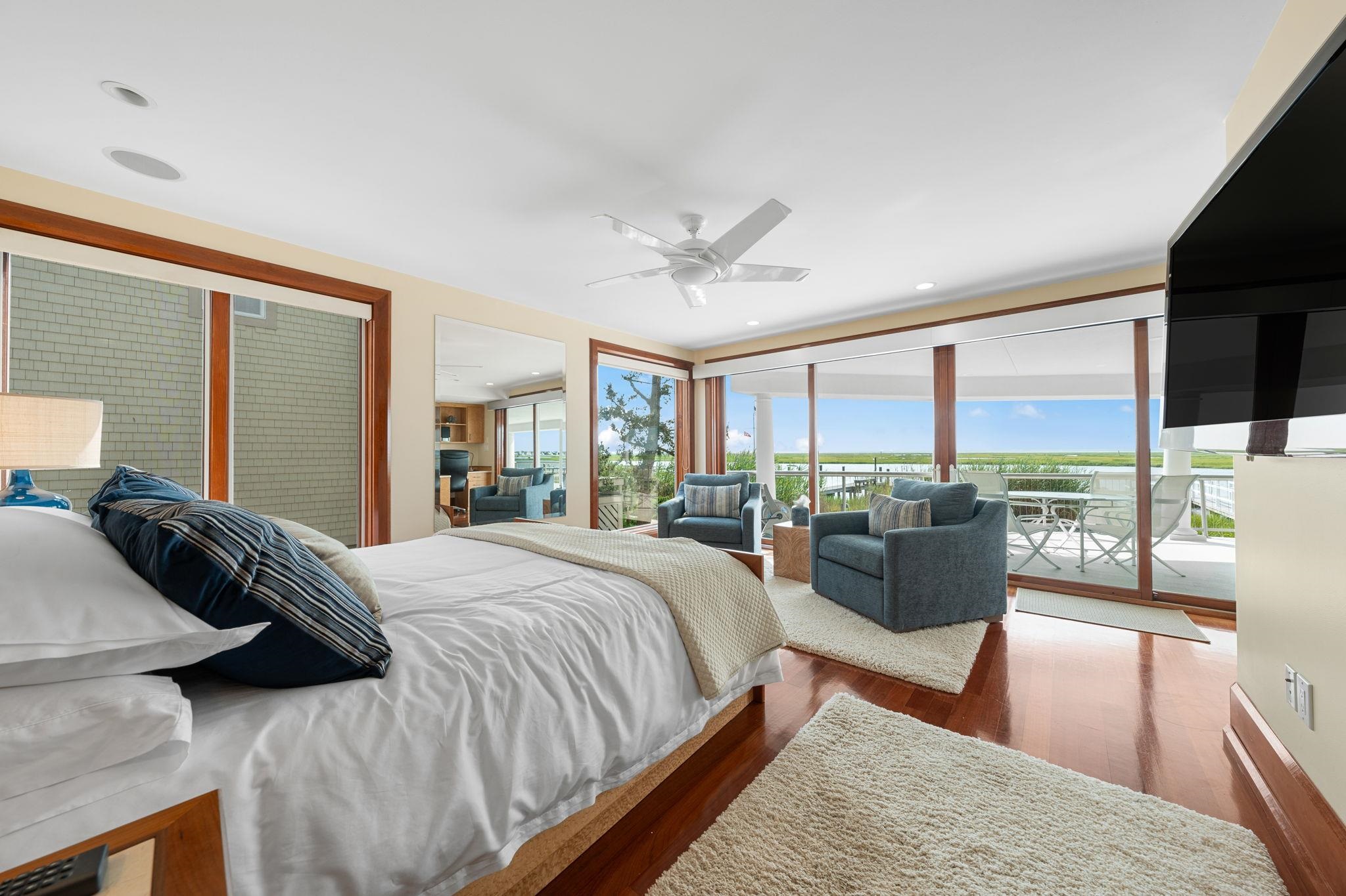 5878 Ocean Drive Avalon, NJ 08202 - Photo 13 of 50 a bedroom with a large bed and a large window