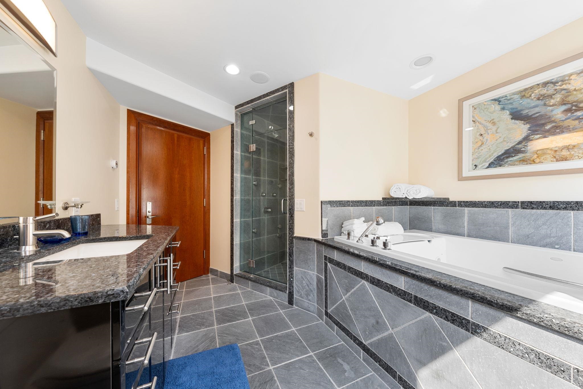 5878 Ocean Drive Avalon, NJ 08202 - Photo 14 of 50 a bathroom with a granite countertop double vanity sink a mirror and a bathtub