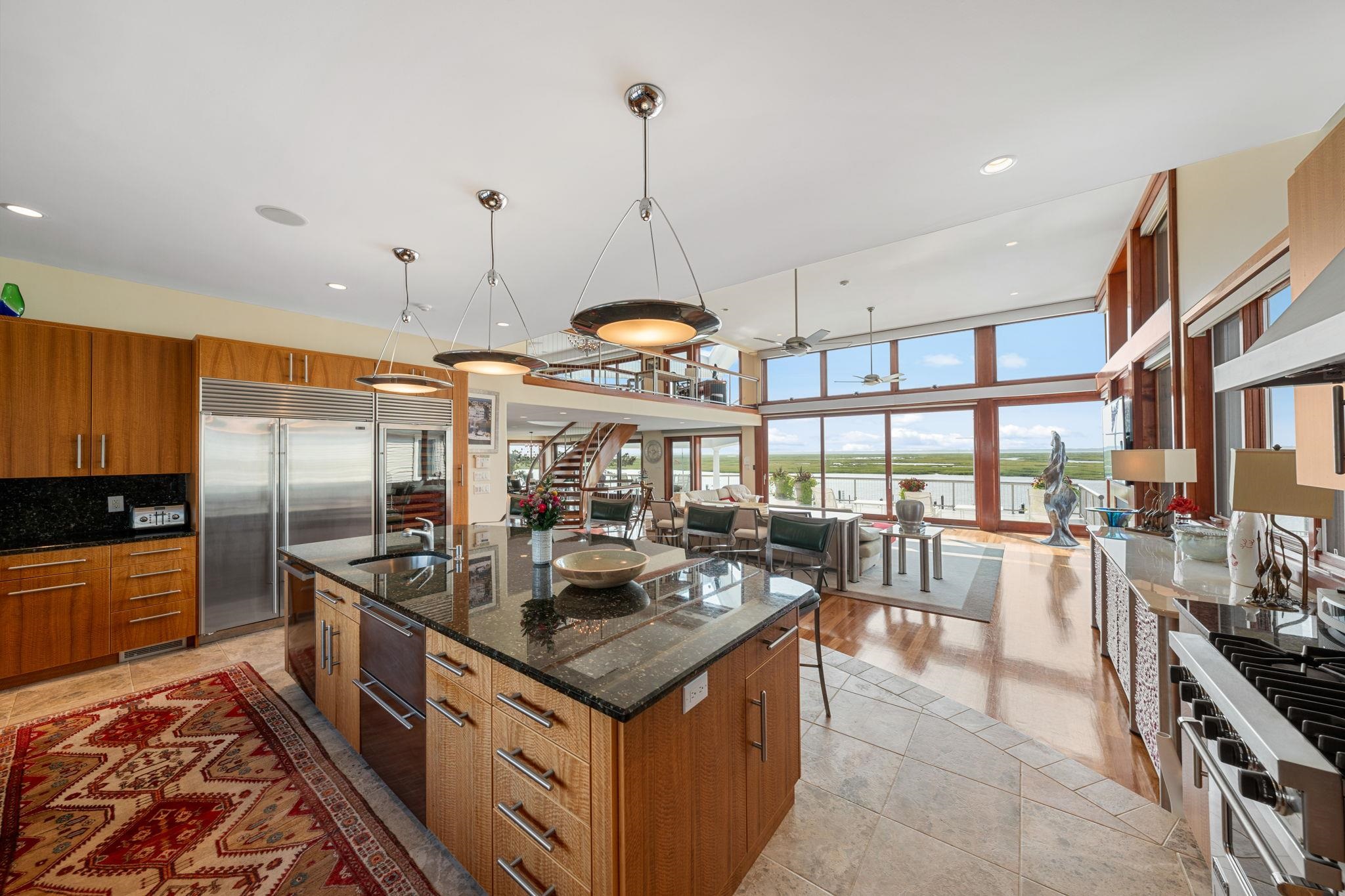 5878 Ocean Drive Avalon, NJ 08202 - Photo 22 of 50 a open kitchen with stainless steel appliances granite countertop a sink a stove and a wooden floors