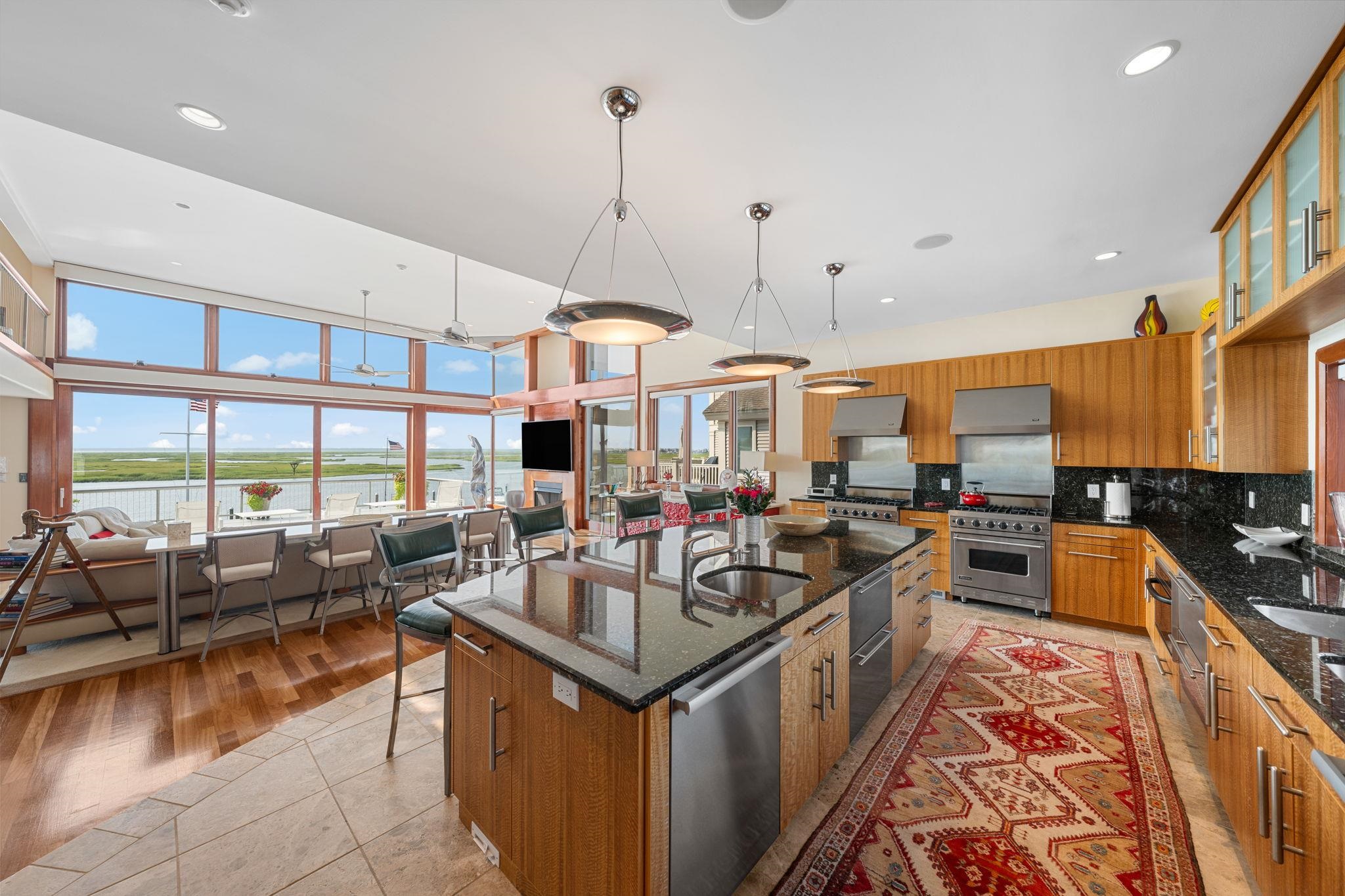 5878 Ocean Drive Avalon, NJ 08202 - Photo 23 of 50 a kitchen with stainless steel appliances granite countertop a sink and a large window