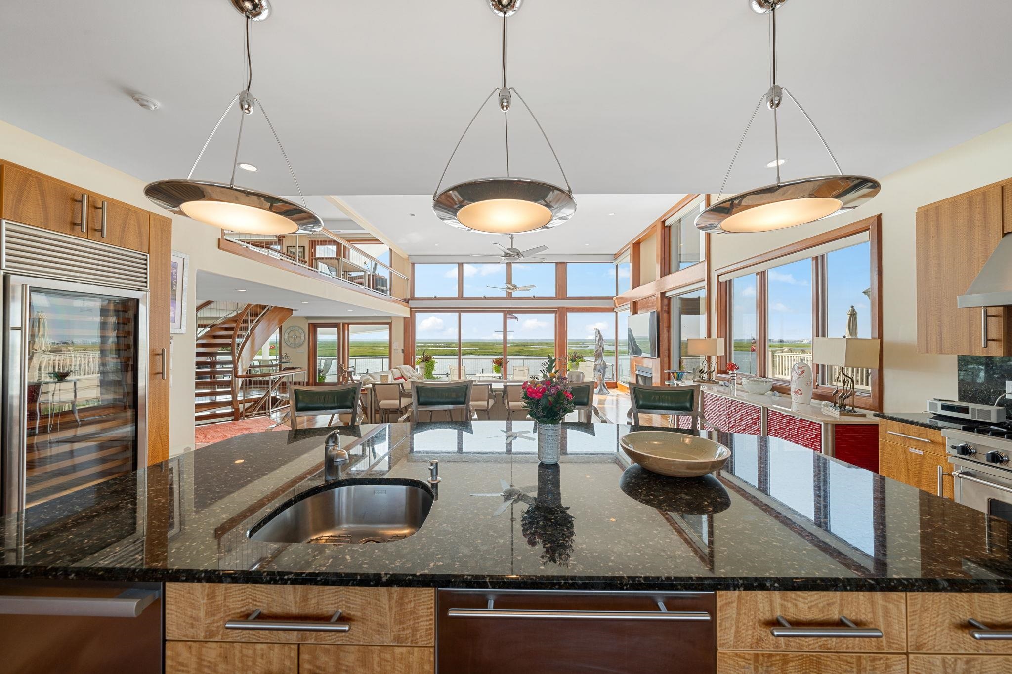 5878 Ocean Drive Avalon, NJ 08202 - Photo 24 of 50 a kitchen counter with a granite countertop sink and cabinets