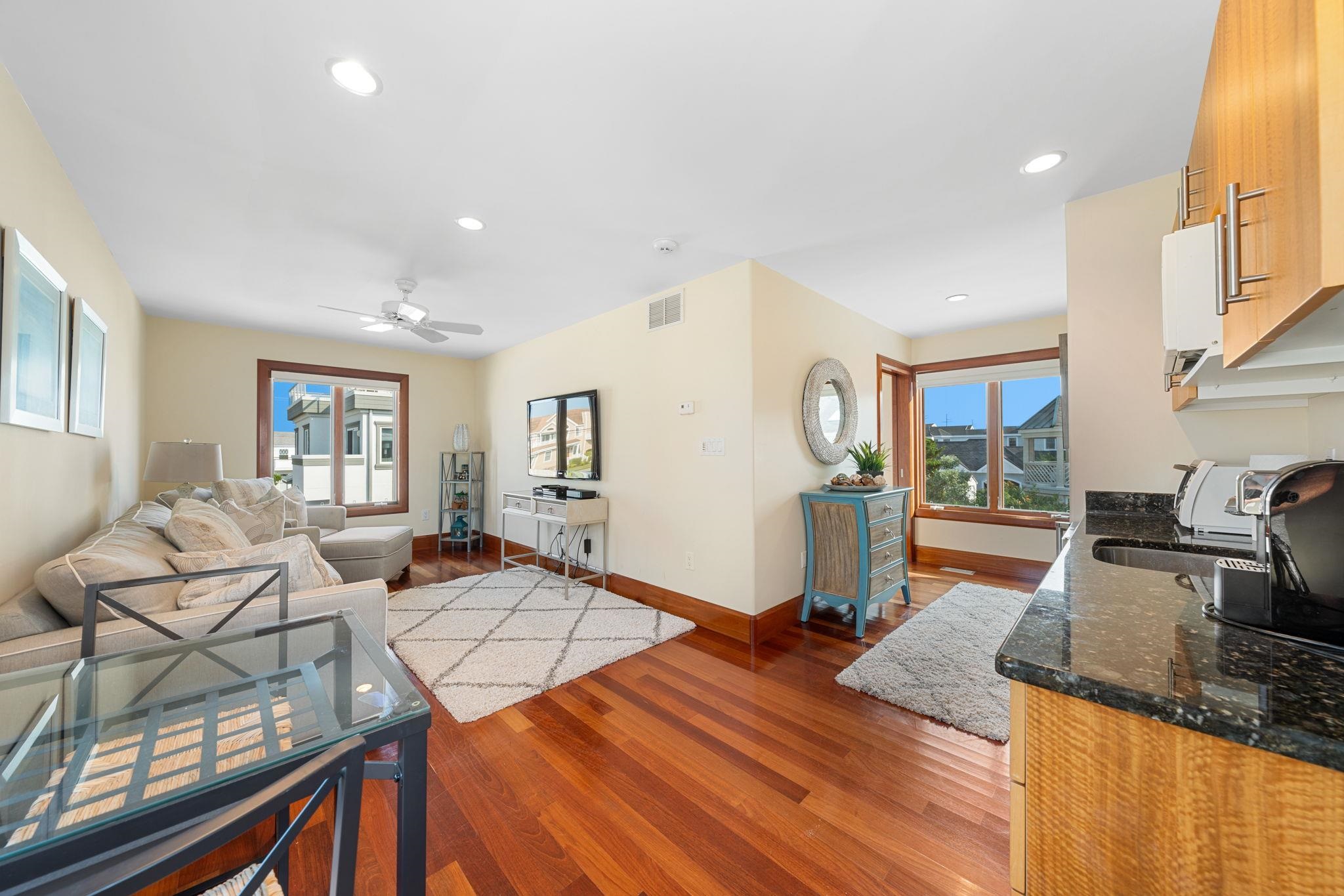 5878 Ocean Drive Avalon, NJ 08202 - Photo 45 of 50 a living room with furniture a flat screen tv and floor to ceiling window