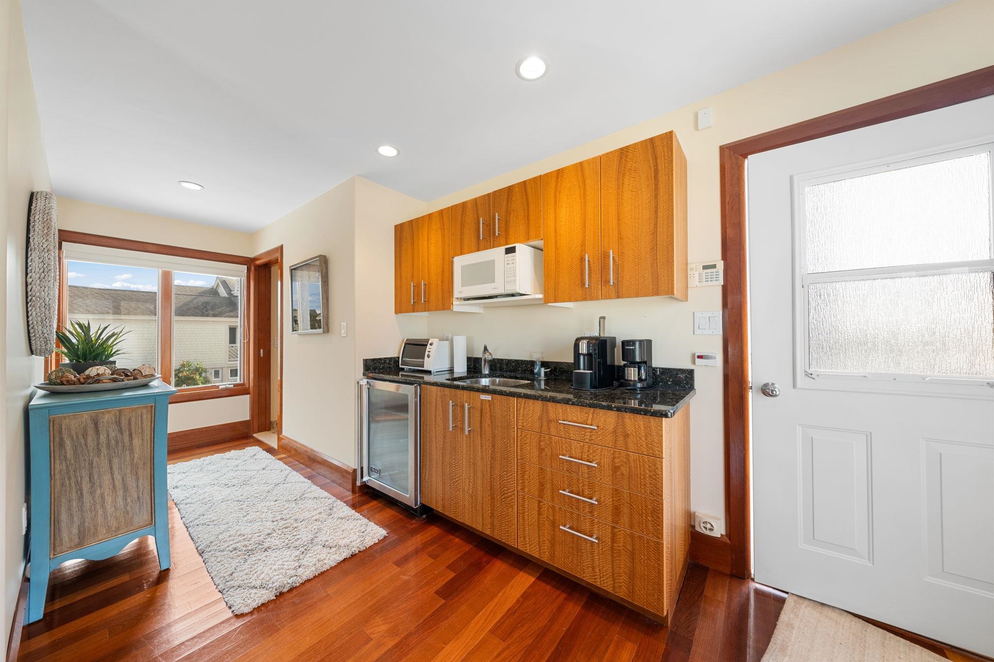5878 Ocean Drive Avalon, NJ 08202 - Photo 48 of 50 a kitchen with stainless steel appliances granite countertop wooden cabinets a stove a sink and a large window