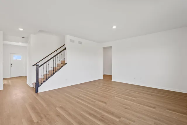 a view of an empty room with wooden floor