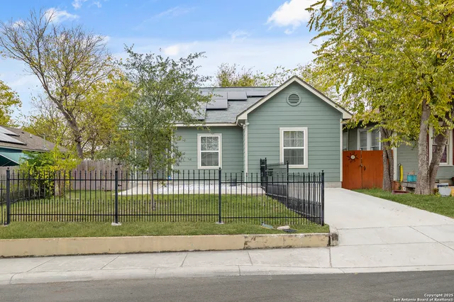 a view of a house with a small yard and plants