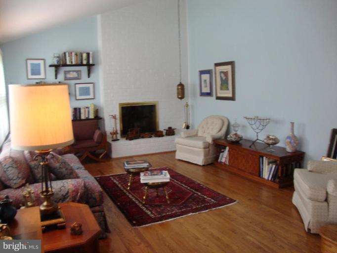 822 Hopewood Road Pikesville, MD 21208 - Photo 3 of 9 a living room with furniture and a fireplace