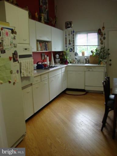 822 Hopewood Road Pikesville, MD 21208 - Photo 4 of 9 a kitchen with sink cabinets and window