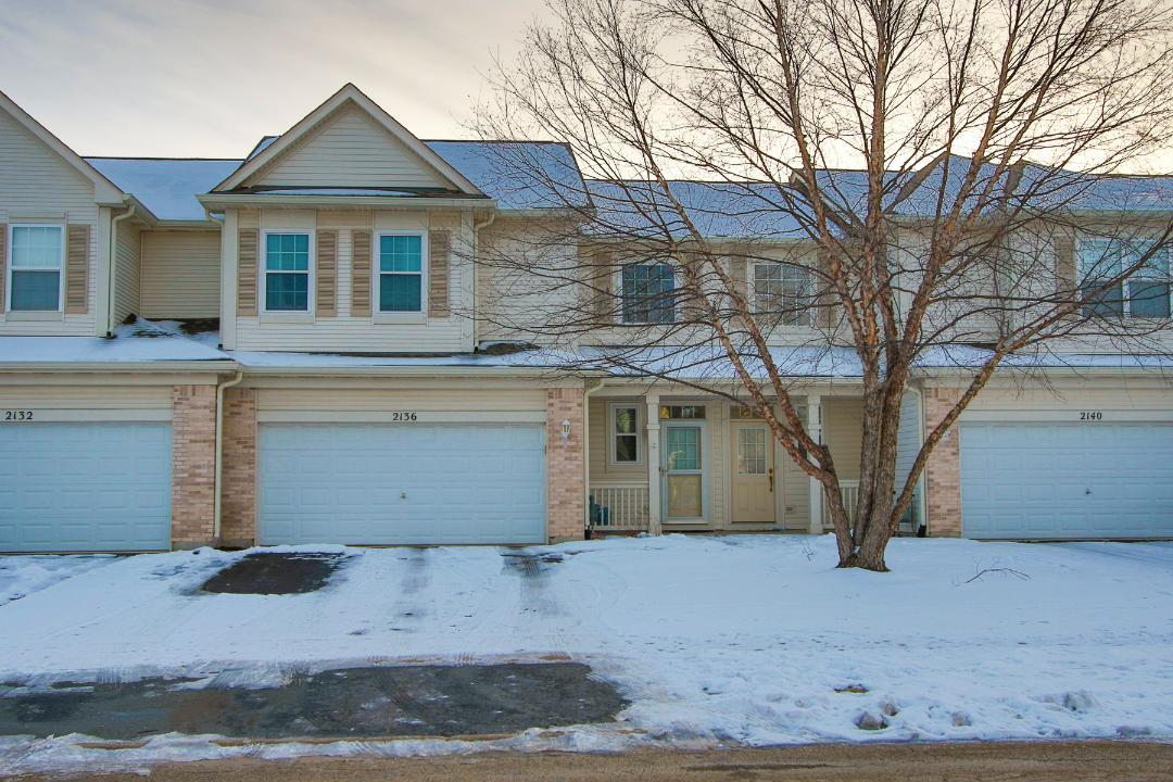 2136 Sunrise Circle Aurora, IL 60503 - Photo 1 of 21 a view of a white house with large tree next to a yard