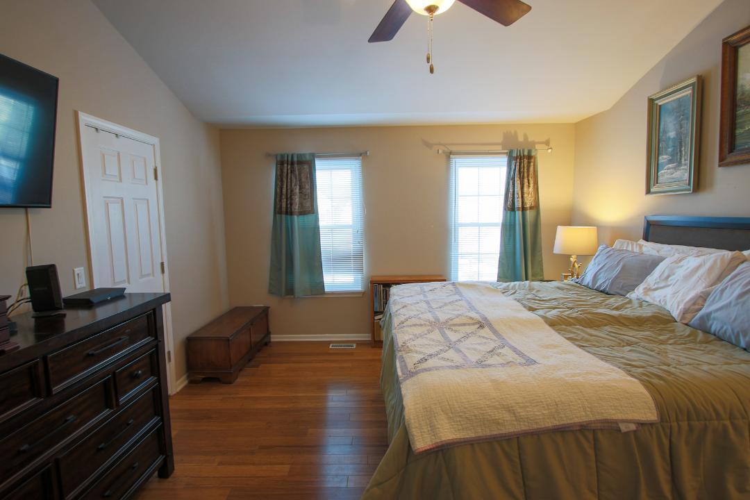 2136 Sunrise Circle Aurora, IL 60503 - Photo 13 of 21 a bedroom with a bed and wooden floor