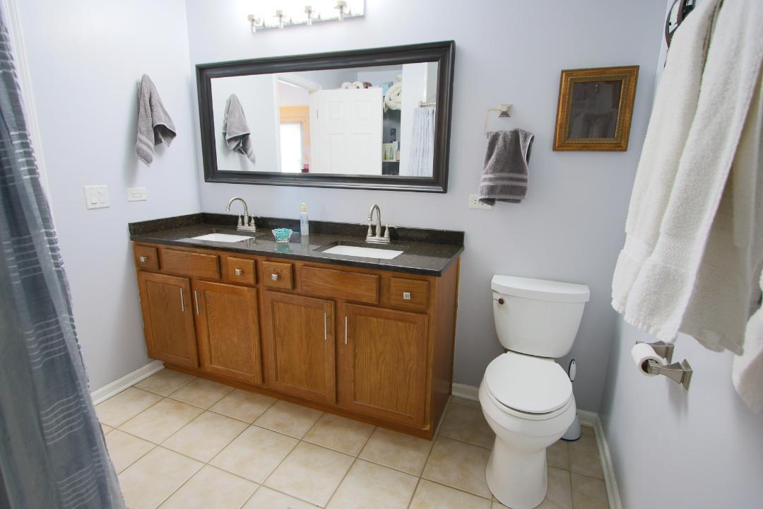 2136 Sunrise Circle Aurora, IL 60503 - Photo 14 of 21 a bathroom with a toilet sink and mirror