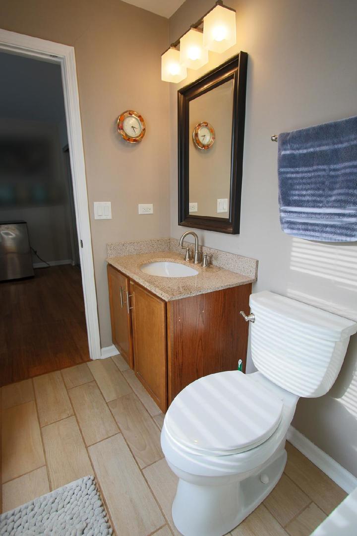 2136 Sunrise Circle Aurora, IL 60503 - Photo 18 of 21 a bathroom with a toilet a sink and mirror