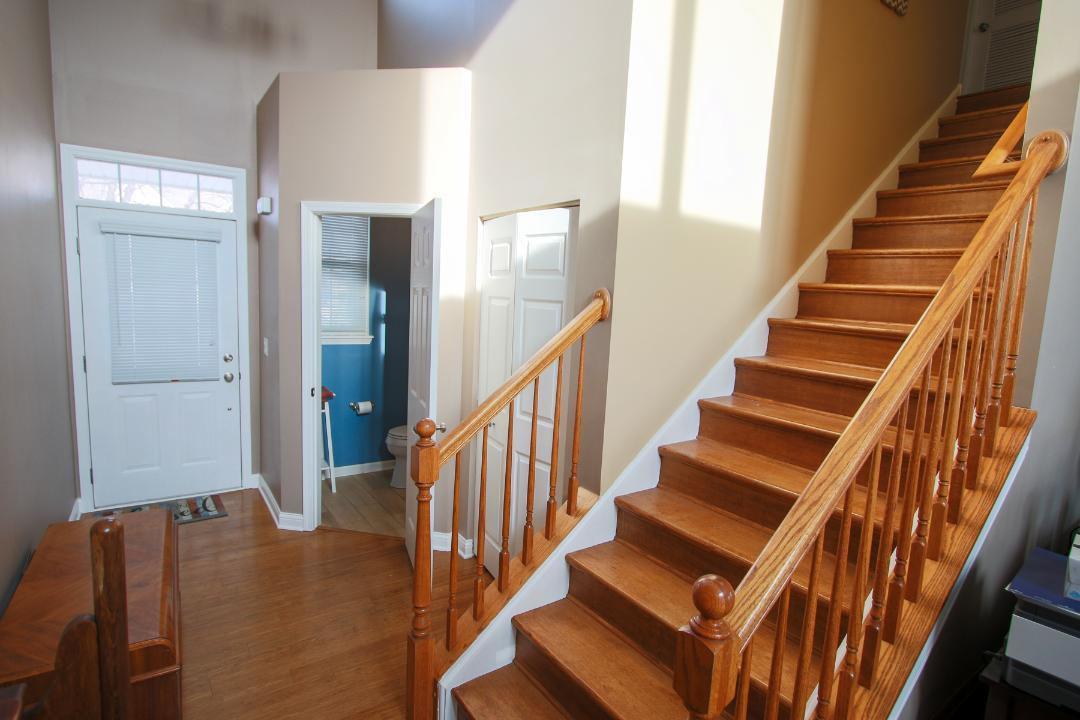 2136 Sunrise Circle Aurora, IL 60503 - Photo 2 of 21 a view of staircase with wooden floor and white walls