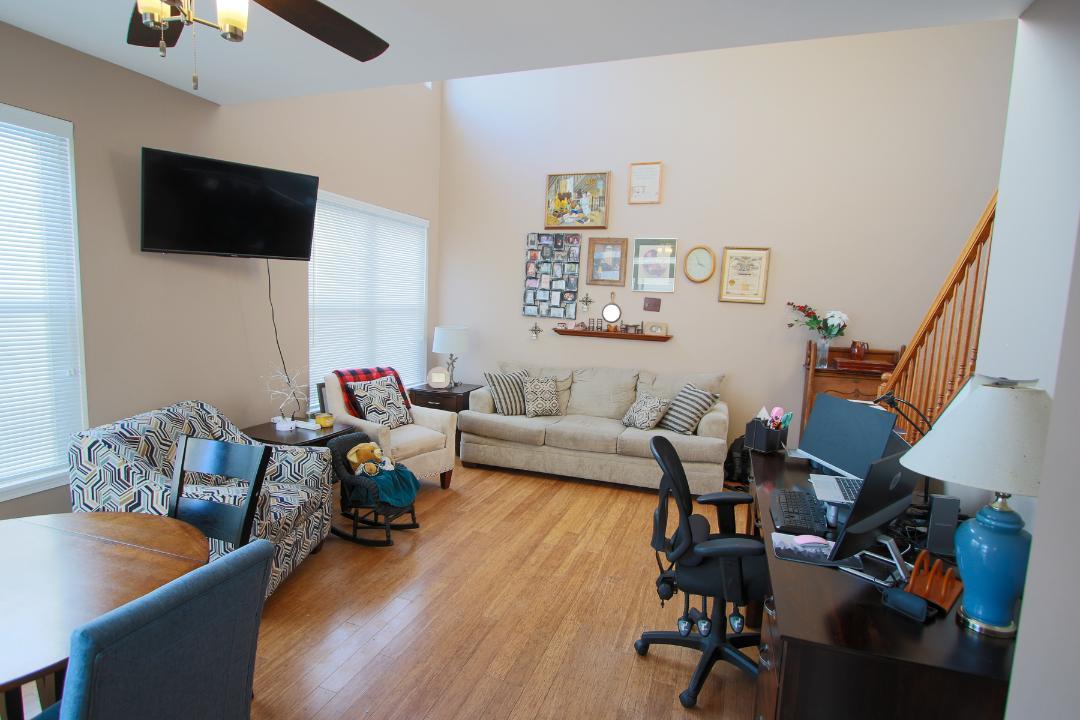 2136 Sunrise Circle Aurora, IL 60503 - Photo 5 of 21 a living room with furniture and a flat screen tv