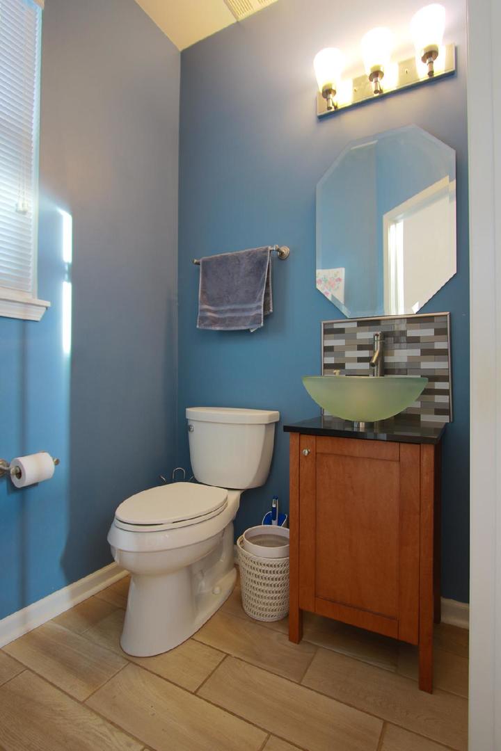 2136 Sunrise Circle Aurora, IL 60503 - Photo 6 of 21 a bathroom with a granite countertop toilet a sink and a mirror